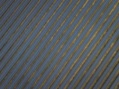 Aerial view of Sunel Gonerby Solar Farm with rows of photovoltaic panels arranged in diagonal patterns across the landscape in Grantham, England, United Kingdom.