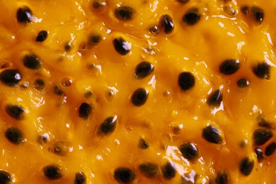 Passion fruit pulp with black seeds close up for tasting and cooking