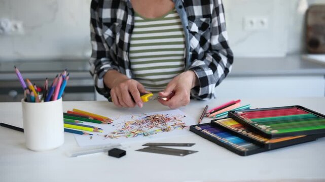 Close-Up Of A Woman Sharpening Colored Pencils