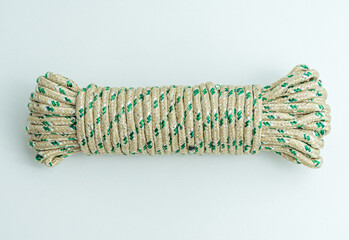Rolled bundle of green and white twisted string rope isolated on white background © arbi wiratama