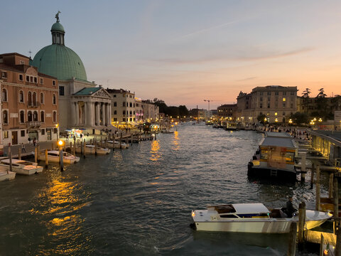Venice, Italy - 04 October 2022: View of San Simeone Piccolo church and boats on the Grand Canal at sunset.