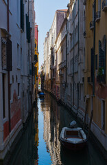 Narrow canal with reflections in Venice © lupiklv
