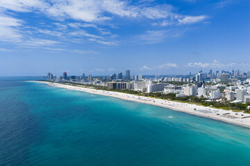 Naklejka na ściany i meble Miami beach with turquoise waters. Aerial view of sandy coastline and waves.