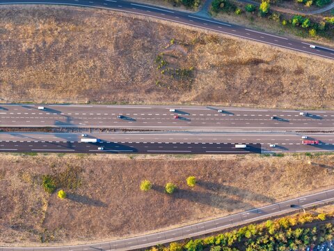 Aerial view of a multi-lane highway with vehicles traveling through the landscape in Sausheim, Grand Est, France.