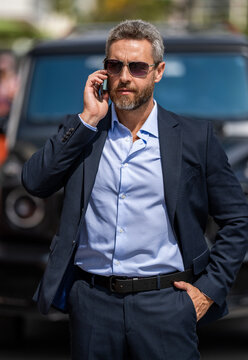 Businessman negotiation online. Man phone conversation. Hispanic business man with phone. Business communication of businessman. Business man walking talking on phone outdoor