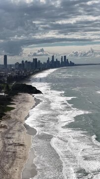 Burleigh Heads aerial view of waves wrapping around the headland, Gold Coast, Queensland Australia - vertical video
