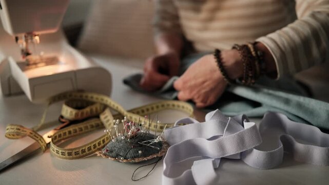 Close-Up Of A Woman Pinning Fabric Before Setting Up A Sewing Machine