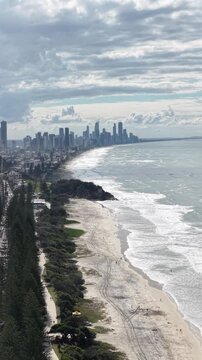 Burleigh Heads aerial drone footage over the point, beach and Surfers Paradise skyline, Gold Coast, Queensland Australia - vertical video