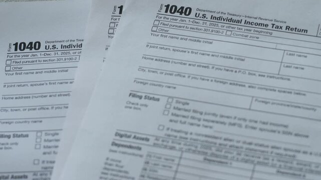 Close-up shot of official US Individual Income Tax Return Form 1040 and Form 4868. Standard documents for filing personal tax returns and requesting an automatic extension.