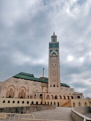 Fototapeta premium The Hassan II Mosque in Casablanca, Morocco, is distinguished by its 210-meter-tall minaret and stands as the city's largest and most iconic Islamic architectural and cultural landmark.