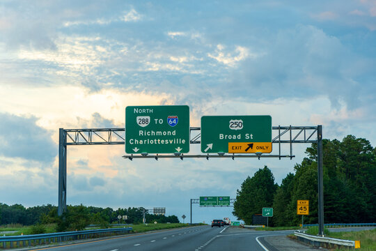 Richmond, Virginia, United States - 09 August 2024: View of highway signs indicating directions to Richmond, Charlottesville, and Broad Street on a multi-lane road.
