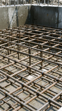 Dense steel reinforcement grid prepared for a concrete foundation or structural slab at a construction site.