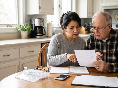 Daughter Helping Elderly Father Prepare for Doctor's Appointment