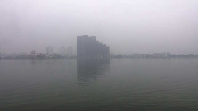 Hanoi, Vietnam. The coast with high-rise buildings and the embankment are covered with urban smog. Heavy air pollution from the monsoon season