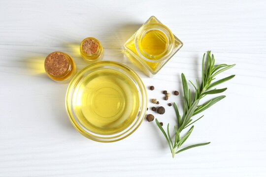Rosemary oil with green rosemary sprig, aromatic oil for cooking. Homemade rosemary oil, natural cooking seasoning. Organic spiced oil. Herbs. Aromatherapy. Healthy cooking.