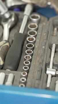 A set of socket wrenches and tools in a box.