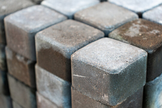 View of stacked grey concrete paving stones in Riga, Latvia.