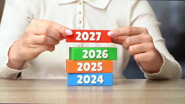 Woman hand holding 2027 year. Beginning of a new year. Time progression, future changes. Trends in innovation, culture, and global developments define the evolving world. Female hand