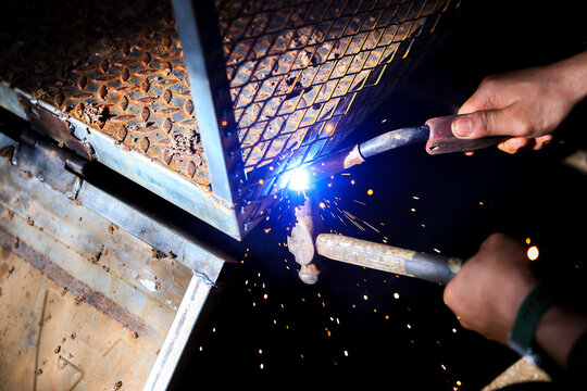 Welding repair worker metal frame steel spark protective glove construction fabrication workshop