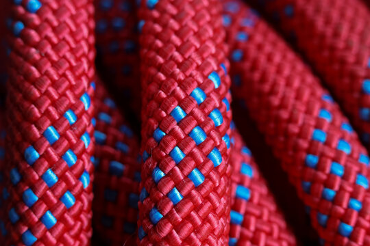 Woven red and blue rope texture showing braided fiber detail and colorful outdoor equipment material with bold contrast and tactile pattern