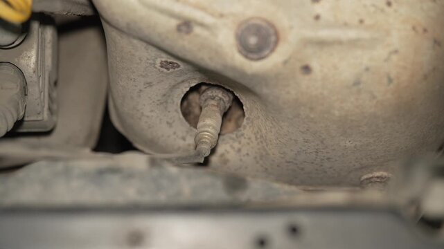 A close up of a car exhaust oxygen sensor lambda probe.