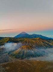 Panoramic view of Mount Bromo volcano crater with dramatic fog and misty morning light in East Java © Wahde Stock