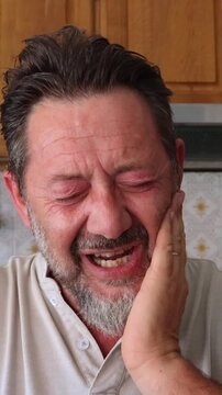 A middle-aged man with a beard is seen suffering from severe tooth pain, holding his jaw and making distressed facial expressions. His agony is palpable as he struggles with the discomfort, emphasizin