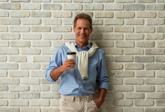 Smiling Man Holding Coffee.