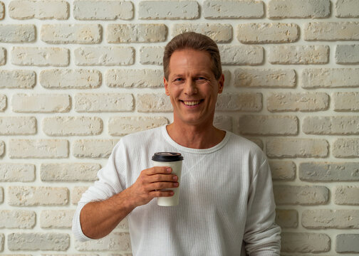 Smiling Man Holding Coffee.
