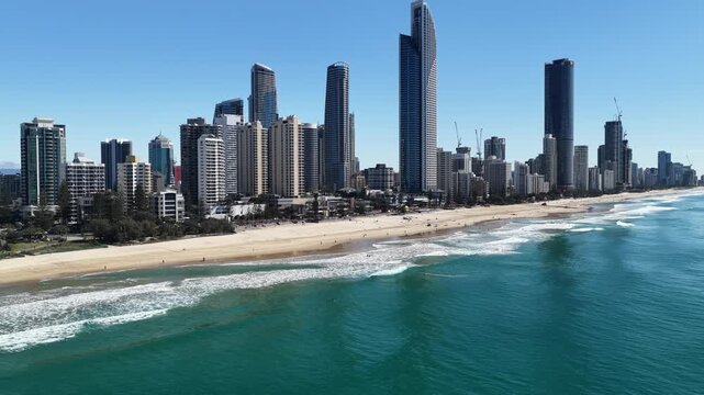 Surfers Paradise aerial view of waves rolling onto golden sand below the towers, Gold Coast, Queensland Australia