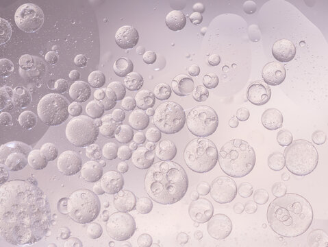 Abstract purple water bubbles essential oil beauty collagen Serum Repair cell background.
