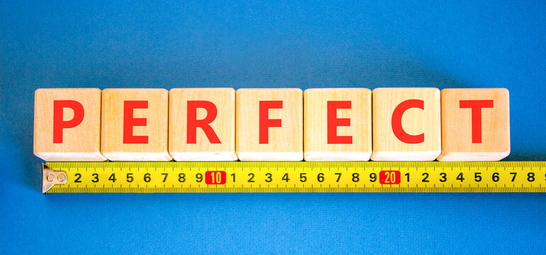 Perfect word symbol. Concept word Perfect on beautiful wooden blocks. Beautiful blue background. Beautiful yellow ruler. Business perfect word concept. Copy space.