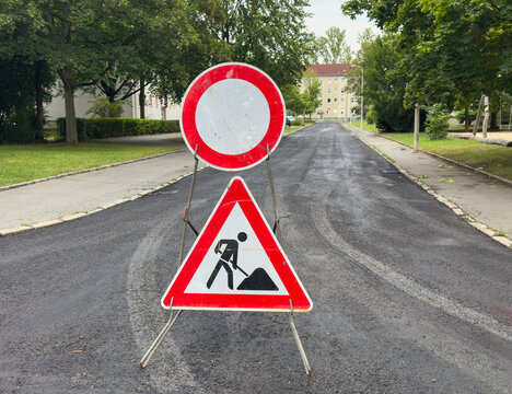 Construction Site Sign on a Newly Renovated Asphalt Road &ndash; Fresh Pavement and Roadworks Safety Concept