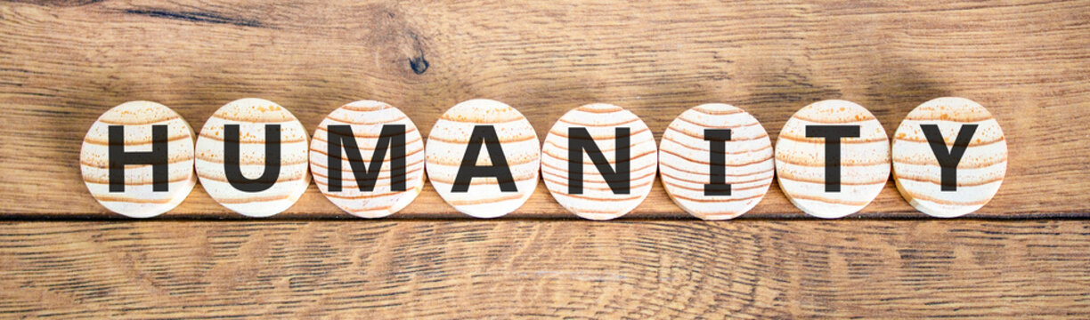 Humanity word symbol. Concept word Humanity on beautiful wooden circles. Beautiful wooden background. Business support help humanity word concept. Copy space.