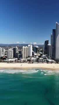 Surfers Paradise aerial footage of the city skyline meeting the Pacific Ocean, Gold Coast, Queensland Australia - vertical video