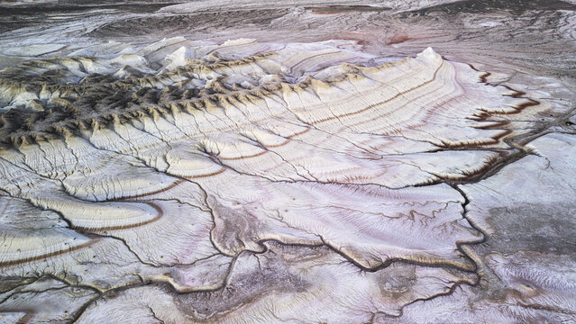 Aerial view of the unique chalk formations and eroded landscape of the Bozzhyra tract with intricate patterns and colorful sedimentary layers in Mangistau, Mangystau Region, Kazakhstan.
