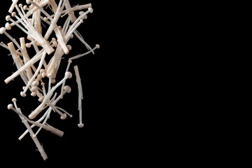 Obraz premium Fresh Enoki Mushrooms Levitating on Black Background with Copy Space
