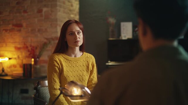 Young couple breaks up in coffee shop, red-haired woman leaves boyfriend alone