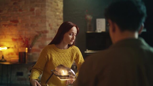 Jealous red-haired woman argues with boyfriend in cafe after misunderstanding