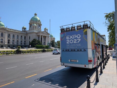 02 August 2026, Belgrade, Serbia: Expo 2027 advertising covers a tour bus parked on a Belgrade boulevard during preparations for the international specialized exhibition. 