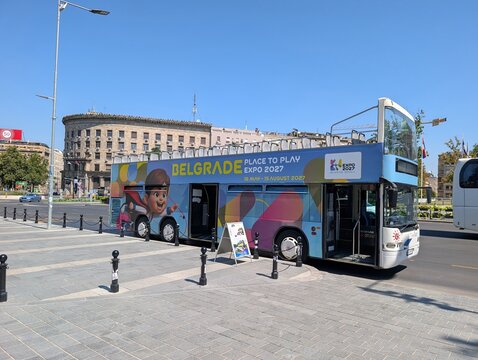 02 August 2026, Belgrade, Serbia: Expo 2027 advertising covers a tour bus parked on a Belgrade boulevard during preparations for the international specialized exhibition.
