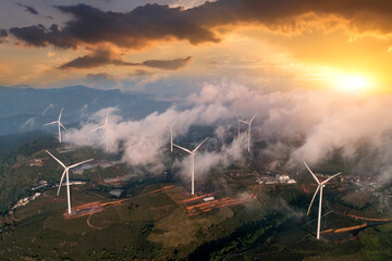 Beautiful wind turbine in the countryside in the time of sunset background. Wind Turbines Windmill Power Farm © aapsky