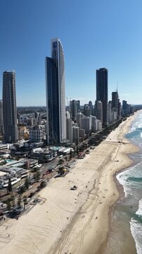 Surfers Paradise aerial drone footage over the beach, surf and high-rise skyline, Gold Coast, Queensland Australia - vertical video