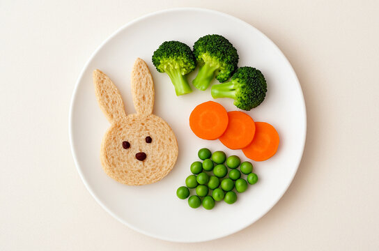 Cute children&rsquo;s meal served on a colorful plate, arranged with fresh vegetables and healthy ingredients. Perfect for kids&rsquo; menu, healthy eating, and nutrition promotion.
