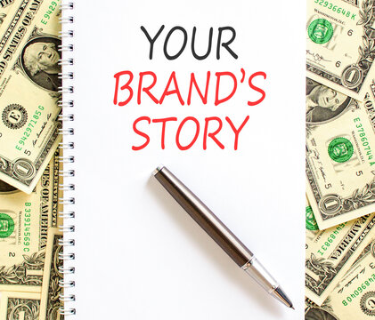 Branding and your brands story symbol. Concept words Your brands story on beautiful white note. Beautiful dollar bills background. Business branding your brands story concept. Copy space.