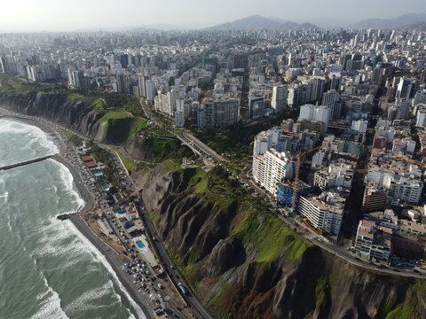 Aerial view of the Costa Verde coastline in Miraflores, featuring steep cliffs, urban buildings, and the Pacific Ocean in Miraflores, Provincia de Lima, Peru.