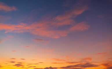 Fototapeta premium Vibrant Sunset Sky with Dramatic Purple and Orange Clouds,A stunning and vibrant sunset sky, featuring a beautiful blend of deep purple, blue, and fiery orange clouds. The dramatic cloud formations.
