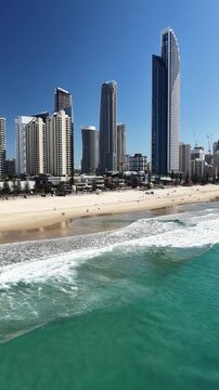 Surfers Paradise aerial footage of the city skyline meeting the Pacific Ocean, Gold Coast, Queensland Australia - vertical video