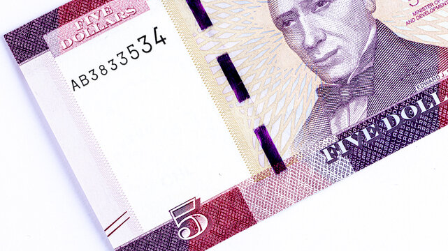 Close-up of a 5 Liberian dollars banknote featuring a portrait of Presiden. Detailed macro shot of Liberia currency paper money bill.