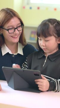 Woman girl tablet classroom learning teacher student education child technology for digital study focused school device calm bright setting